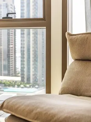 a bedroom with a view of a city from a window at The Harbor Heights 1BR in Palace Residences Creek in Dubai