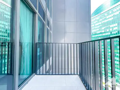 a balcony in a tall building with glass windows at Stylish 1Bedroom with Balcony & View Dubai in Dubai