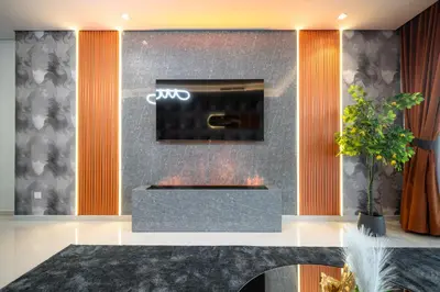 a fireplace in a room with orange and gray at 64th-Floor Rooftop Pool with Burj Khalifa View, 2BR Apartment in Paramount Hotel Midtown in Dubai