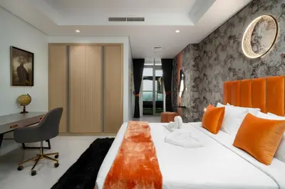 a bedroom with a large bed and a desk at 64th-Floor Rooftop Pool with Burj Khalifa View, 2BR Apartment in Paramount Hotel Midtown in Dubai