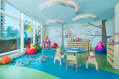a childs play room with toys and a table at Damac Maison Distinction in Dubai