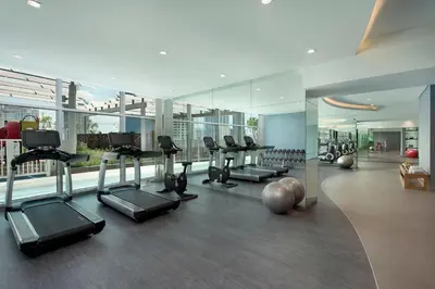 a gym with treadmills and exercise equipment in a building at Damac Maison Distinction in Dubai