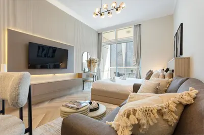 a living room with a couch and a tv at Marina Seaside Living prime location by the beach in Dubai