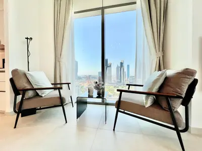 two chairs in a room with a large window at Downtown Views 2BR - Dubai Mall, Fountain & Burj Khalifa access in Dubai