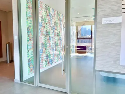 a glass door in a building with a mural on the wall at Downtown Views 2BR - Dubai Mall, Fountain & Burj Khalifa access in Dubai