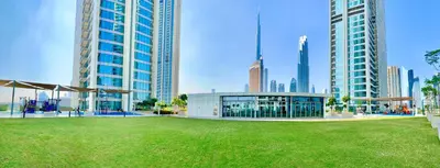 a large building in a city with tall buildings at Downtown Views 2BR - Dubai Mall, Fountain & Burj Khalifa access in Dubai