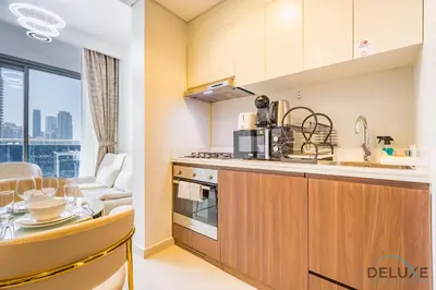 a kitchen with a sink and a counter top at Charming 1BR Apartment in Vera Tower, Business Bay by Deluxe Holiday Homes in Dubai