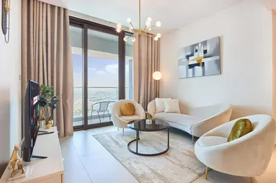 a living room with white furniture and a large window at Beachfront 1BR Retreat at Address JBR in Dubai