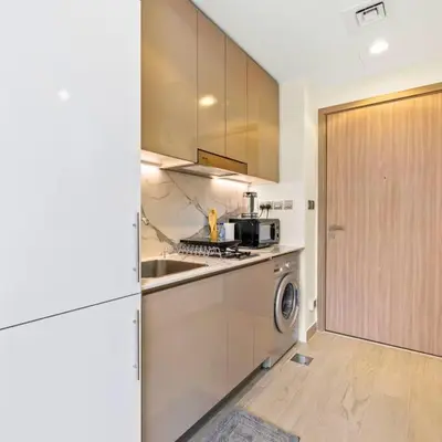 a kitchen with a sink and a stove top oven at Azizi Riviera 16 studio with Kitchenet - Ideal for monthly in Dubai