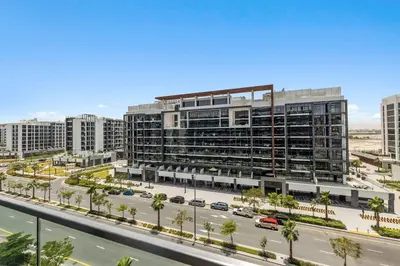 an aerial view of a large building with a parking lot at Azizi Riviera 16 studio with Kitchenet - Ideal for monthly in Dubai