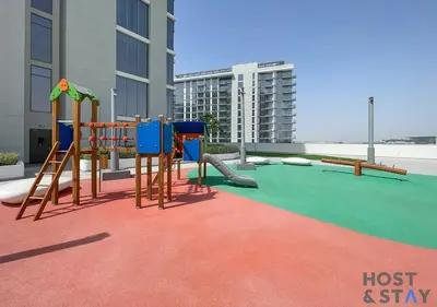 a play area with a playground with a slide at 1 Bedroom - Crystal Lagoon - MBR City Meydan in Dubai