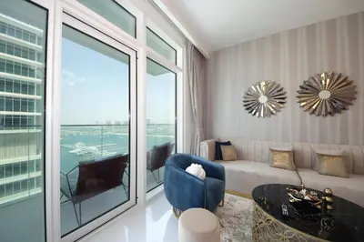 a living room with a couch and a window at Incredible Sea view 2BHK - Private beach Access - Emaar Beachfront in Dubai