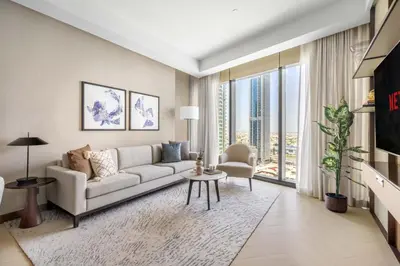 a living room with a couch and a large window at GuestReady - Downtown Dubai luxurious stay in Dubai
