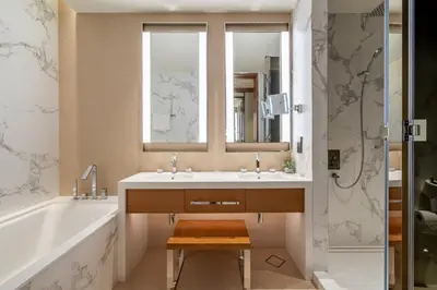 a bathroom with a sink and a tub and a mirror at GuestReady - Downtown Dubai luxurious stay in Dubai