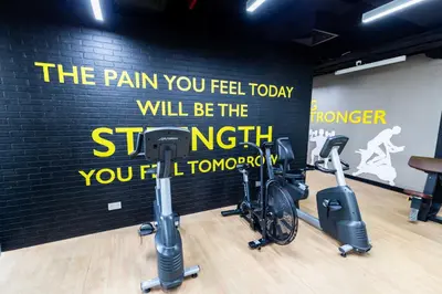 a gym with two bikes parked next to a wall at Dubai Downtown Dubai Mall & Burj Khalifa DIFC 5 mins in Dubai