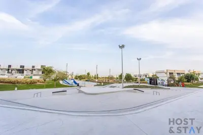 a skate park with a skateboard ramp in a park at Lively 1 BR in Damac Hills, Dubai - Host & Stay in Dubai