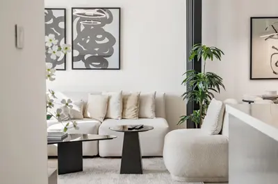 a living room with a white couch and a table at Panoramic Sea View 2BR in Forte Downtown - Allsopp&Allsopp in Dubai