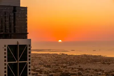 a sunset view of a city from a skyscraper at Panoramic Sea View 2BR in Forte Downtown - Allsopp&Allsopp in Dubai