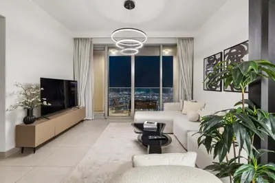 a living room with a couch and a tv at Panoramic Sea View 2BR in Forte Downtown - Allsopp&Allsopp in Dubai