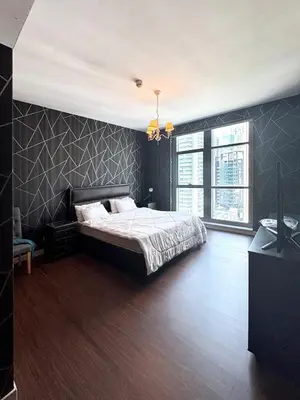 a bedroom with a bed with a black wall at Claren Tower 2 - Downtown by Golden Casa in Dubai