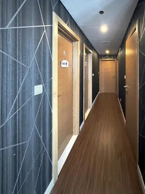a hallway with wooden floors and blue walls at Claren Tower 2 - Downtown by Golden Casa in Dubai