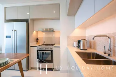 a kitchen with a sink and a stove at LUX The Marina Vista Beachfront Suite 2 in Dubai