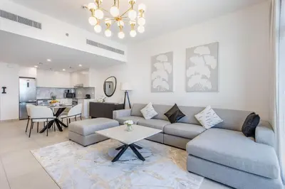a living room with a couch and a table at One Bedroom Apartment in Madinat Jumeirah Living by The S Holiday Homes in Dubai