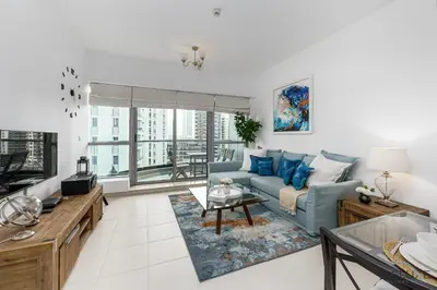 a living room with a couch and a table at Charming 1BR in The Point Tower, Dubai Marina by Deluxe Holiday Homes in Dubai