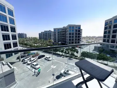 a view of a parking lot from a balcony at Mag 510: 2-Bedroom Elegance in Dubai