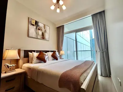 a bedroom with a large bed and a large window at Lux BnB I Vera Residences I Burj Views in Dubai