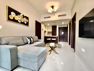a living room with a couch and a tv at Lux BnB I Vera Residences I Burj Views in Dubai