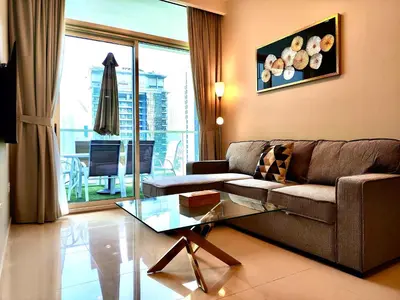 a living room with a couch and a glass table at Lux BnB I Vera Residences I Burj Views in Dubai