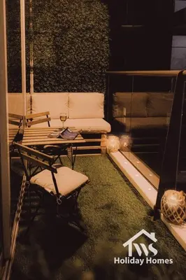a balcony with a couch and a table and a chair at The Urban Oasis - Harmony in Dubai