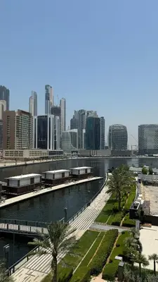 a body of water with a city in the background at Exclusive Canal Waterfront Views 15 Northside in Dubai