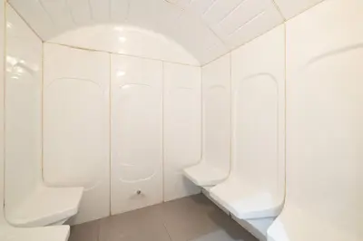 a bathroom with white walls and white toilets at Large 1BR in JVC Sleeps 4 Rooftop, Pool & Gym in Dubai