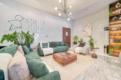 a living room with a couch and a table at Stella Stays Lana Tower in Dubai