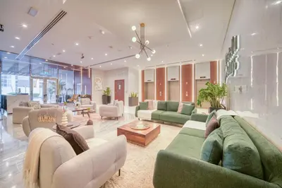 a large living room with couches and tables at Stella Stays Lana Tower in Dubai