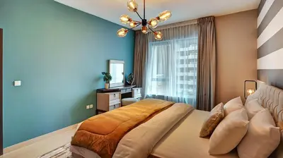 a bedroom with a large bed and a window at 29Boulevard - Modern 2BHK by Radiance Vacation Stays in Dubai