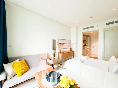 a living room with a white couch and a table at Luxurious Sea-View Studio in Seven Palm - 20AB8 in Dubai
