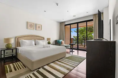 a bedroom with a large bed and a balcony at StoneTree - Luxury 2 BR - Beach Access in Dubai