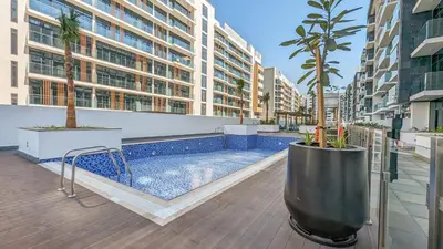 a swimming pool on the roof of a building at Frank Porter - Riviera 27 in Dubai