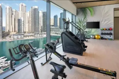 a gym with a view of a city at Delightful 2BR Apartment in VIDA Residences Dubai Marina by Deluxe Holiday Homes in Dubai