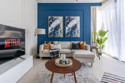 a living room with a couch and a tv at Guest Favourite! Beautiful 1 bedroom apartment in Dubai