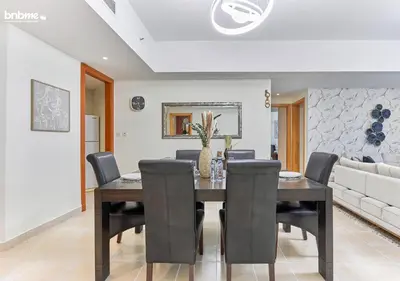 a dining room with a table and chairs at bnbmehomes - DAMAC Waves Tower in Dubai