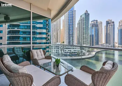 a balcony with chairs and a view of a city at bnbmehomes - DAMAC Waves Tower in Dubai