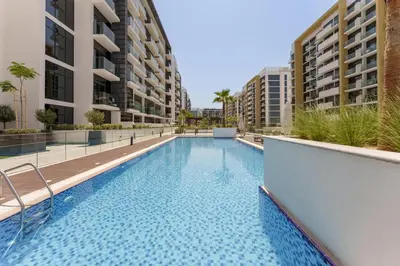 a swimming pool in the middle of a building at Chic 1BR Apartment in Azizi Riviera, Meydan in Dubai