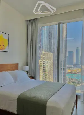a bedroom with a bed and a large window at VIP Experience Dubai Downtown at Forte Tower - Burj Khalifa and Fountain View - Modern Luxury Apartments in Dubai