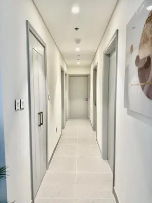 a hallway with white walls and white floors and doors at VIP Experience Dubai Downtown at Forte Tower - Burj Khalifa and Fountain View - Modern Luxury Apartments in Dubai
