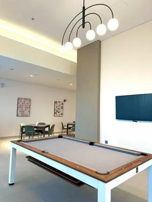 a ping pong table in a room with a dining room at VIP Experience Dubai Downtown at Forte Tower - Burj Khalifa and Fountain View - Modern Luxury Apartments in Dubai