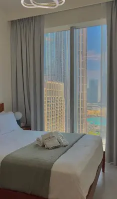 a bedroom with a bed and a large window at VIP Experience Dubai Downtown at Forte Tower - Burj Khalifa and Fountain View - Modern Luxury Apartments in Dubai